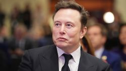 Elon Musk listens as U.S. President-elect Donald Trump addresses a House Republicans Conference meeting at the Hyatt Regency on Capitol Hill on November 13, 2024 in Washington, DC.