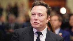 Elon Musk listens as U.S. President-elect Donald Trump addresses a House Republicans Conference meeting at the Hyatt Regency on Capitol Hill on November 13, 2024 in Washington, DC.