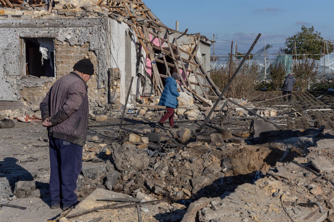 A local resident inspects a crater in the courtyard of a destroyed building following a missile attack at an undisclosed location in the Odesa region of Ukraine on November 17, 2024.