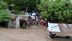 People look at the flooding of the Choluteca river in Tegucigalpa on November 17, 2024, due to the heavy rains left by tropical storm Sara. Tropical storm Sara left 45,329 people affected in Honduras, of which more than a thousand have been left homeless or taken to shelters, according to local authorities. (Photo by Orlando SIERRA / AFP) (Photo by ORLANDO SIERRA/AFP via Getty Images)