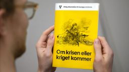 A man holds the new version of the preparedness booklet "If the crisis or war comes", that will be distributed to all households, on November 18, 2024 in Stockholm, Swede. Sweden on November 18, 2024 began sending some five million pamphlets to residents urging them to prepare for the possibility of war, as neighbouring Finland launched a new preparedness website. (Photo by Claudio BRESCIANI / TT News Agency / AFP) / Sweden OUT (Photo by CLAUDIO BRESCIANI/TT News Agency/AFP via Getty Images)