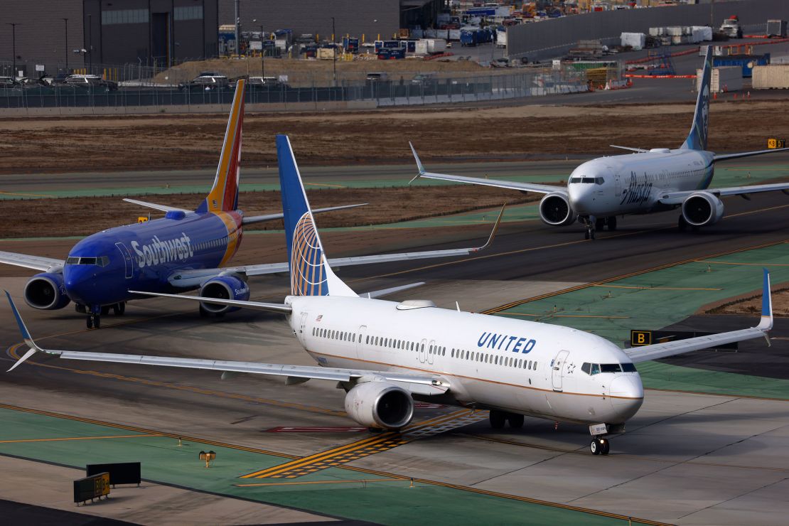 Multiple jets taxi towards the runway at San Diego International Airport in November.