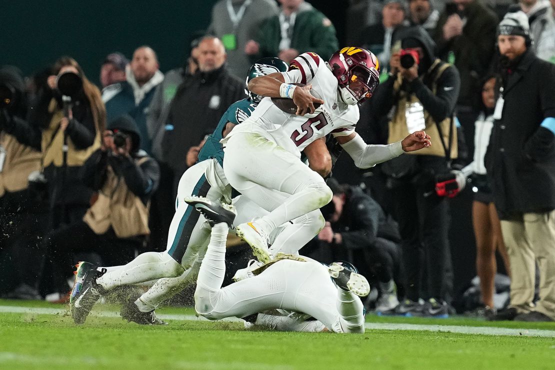 Zack Baun and Reed Blankenship of the Eagles stop Daniels on the key fourth-down run in the fourth quarter.