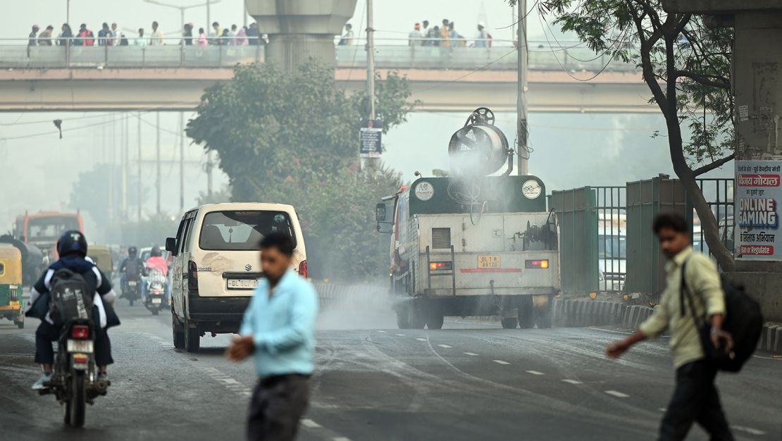 A truck sprinkles water to settle dust particles in New Delhi on November 19, 2024.