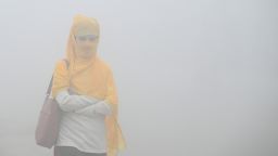 Commuters step out in a foggy winter morning amid rising air pollution, on November 19, 2024 in Greater Noida, India.