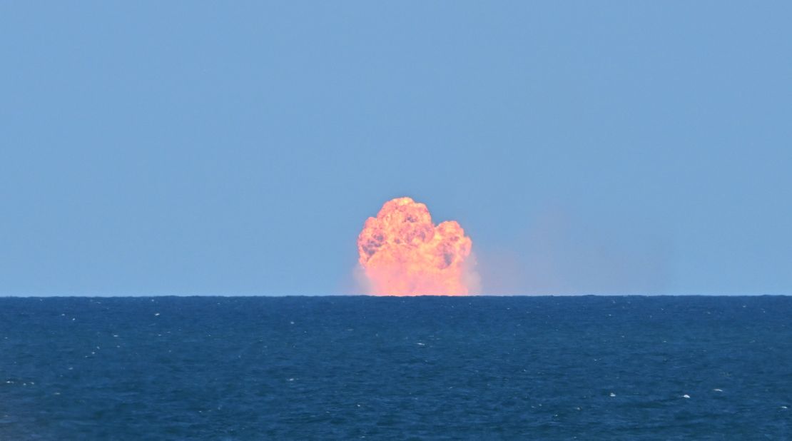 Flames are seen after Starship's Super Heavy Booster splashed down for a water landing off the coast of Texas, on its sixth flight test on November 19, 2024.