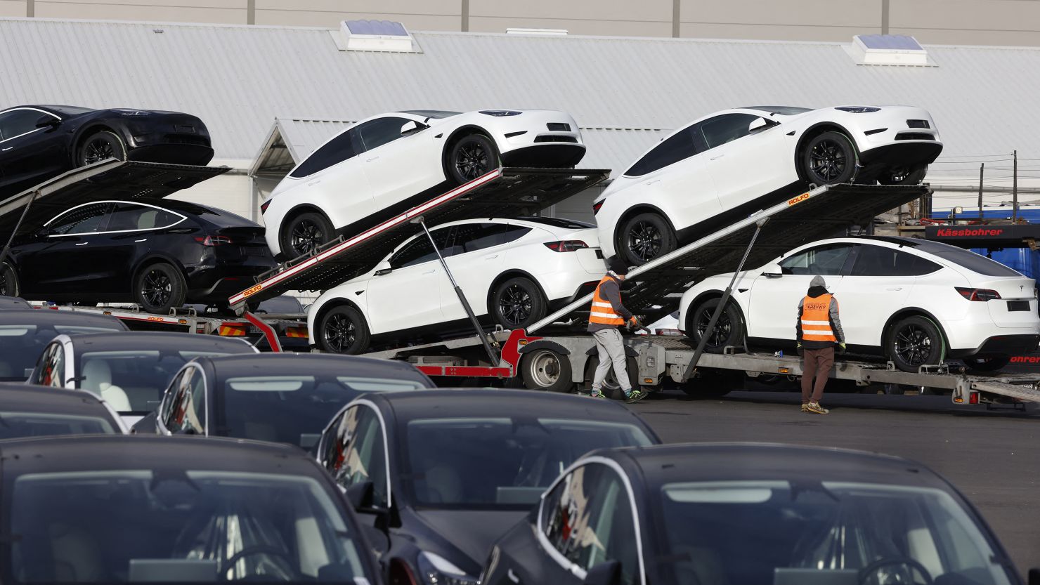 Cars are loaded on trucks outside the US car maker Tesla's German factory near Berlin.