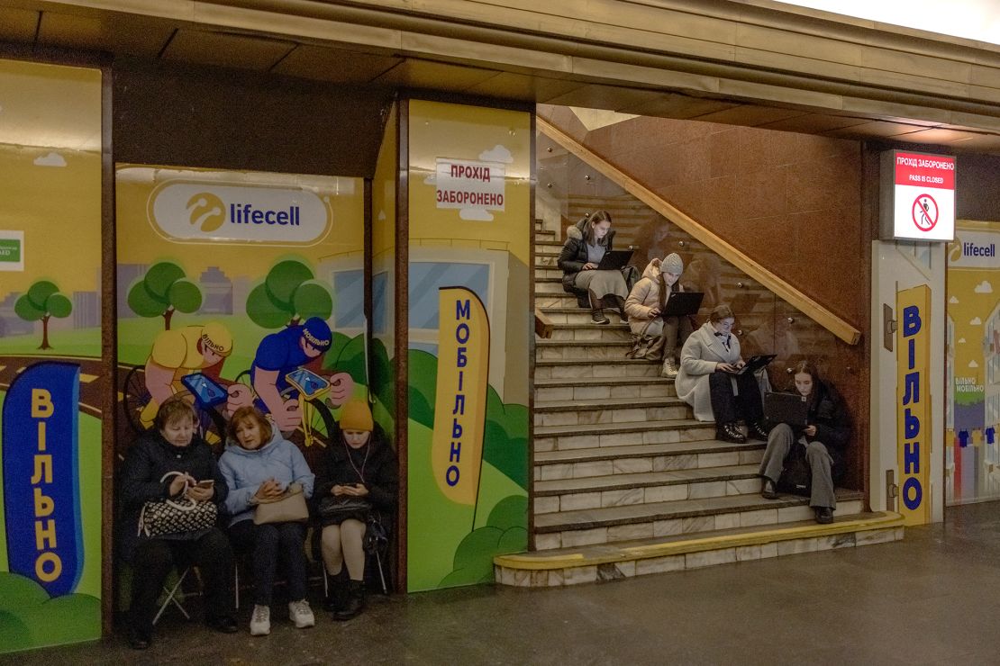 Local residents take shelter in a metro station during an air strike alarm in Kyiv on November 20 amid the Russian invasion of Ukraine.