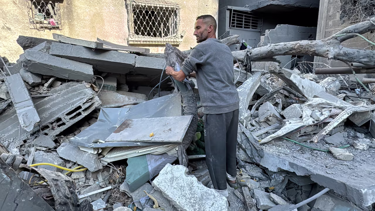 A Palestinian inspects the rubble of a building in Beit Lahia, Gaza on November 21.