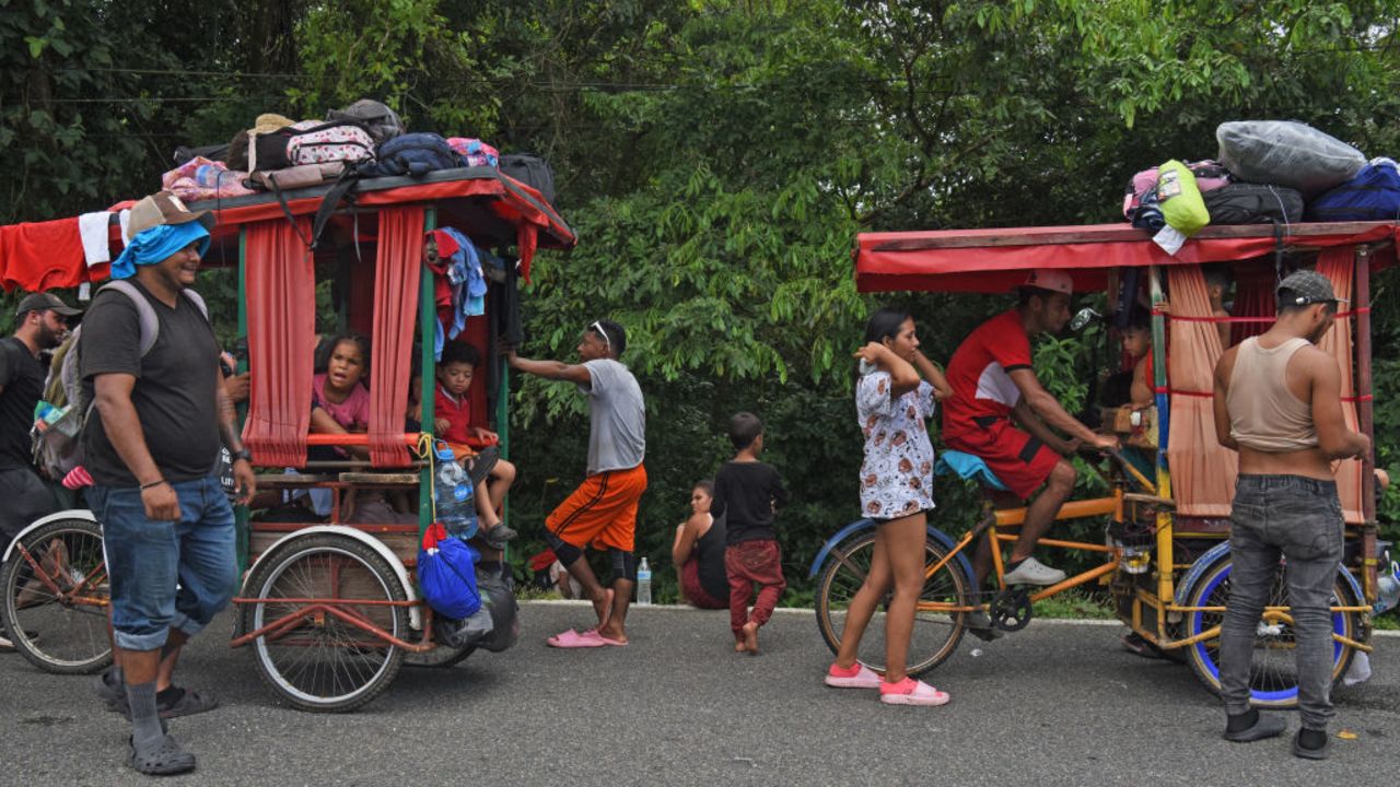 TOPSHOT - Migrants of several nationalities bound to the Mexico-US border ride tricycles in Huixtla, Chiapas State, Mexico on November 21, 2024. (Photo by ISAAC GUZMAN / AFP) (Photo by ISAAC GUZMAN/AFP via Getty Images)