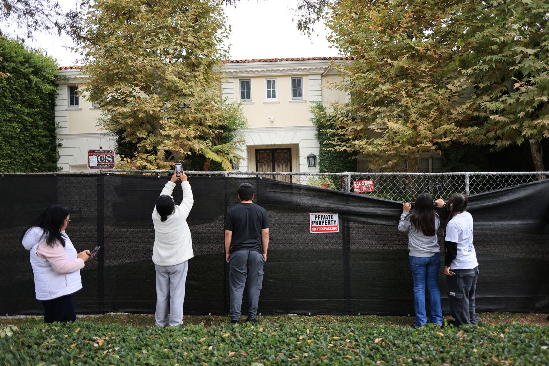 People outside the Beverly Hills, California mansion where brothers Lyle and Erik Menendez murdered their parents in 1989