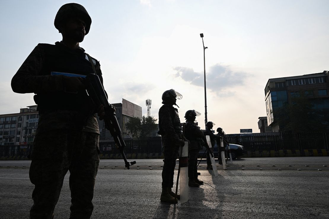 Paramilitary soldiers stand guard at a blocked road leading towards the Red Zone area ahead of a protest rally by jailed former prime minister Imran Khan's Pakistan Tehreek-e-Insaf (PTI) party in Islamabad on November 24.