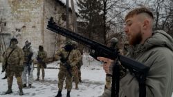 An instructor (R) from The Third Separate Assault Brigade demonstrate how to handle weapons to civilians wearing military uniforms during a military training in Kyiv, on November 23, 2024, amid the Russian invasion of Ukraine. (Photo by Tetiana DZHAFAROVA / AFP) (Photo by TETIANA DZHAFAROVA/AFP via Getty Images)