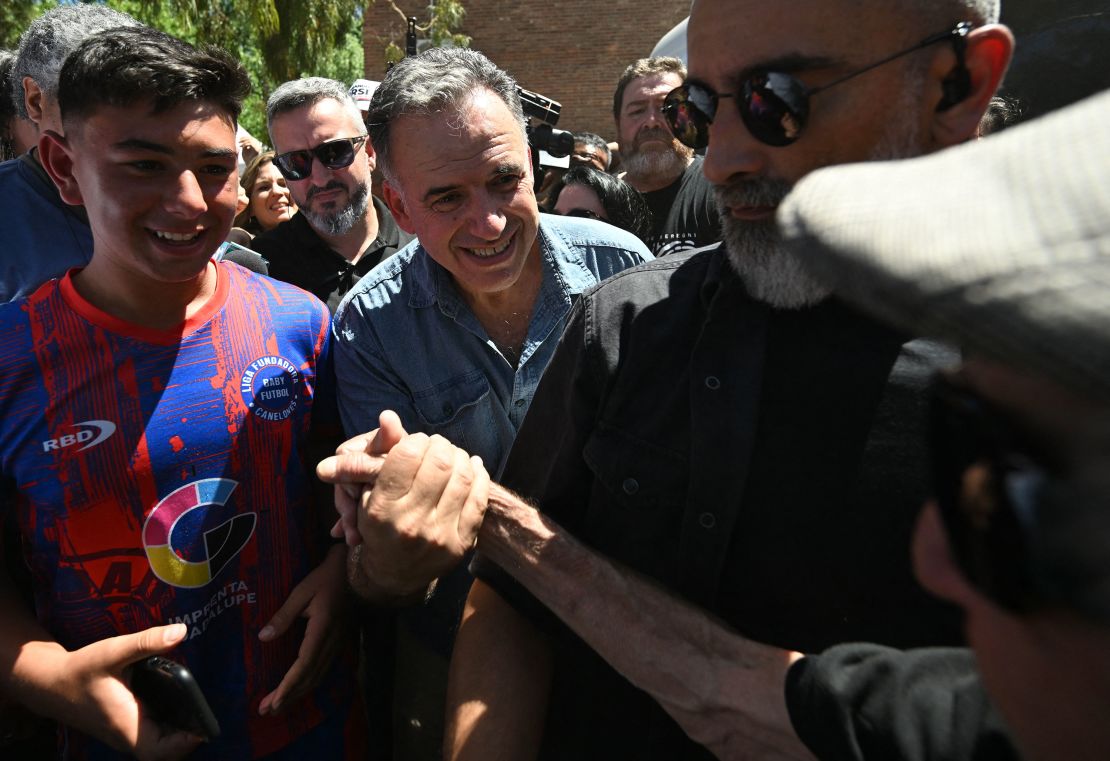 Uruguay's presidential candidate for the Frente Amplio party, Yamandu Orsi, greets supporters after voting during the presidential runoff election in Canelones, Uruguay, on November 24.