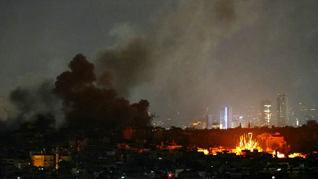 TOPSHOT - Smoke rises and a fireball errupts from the site of Israeli airstrikes that targeted Beirut's southern suburbs on November 24, 2024, amid the ongoing war between Israel and Hezbollah. Lebanon's state media reported a slew of Israeli air strikes on Beirut's southern suburbs on November 24, after the Israeli military posted evacuation calls online for parts of the Hezbollah bastion. (Photo by AFP) (Photo by -/AFP via Getty Images)