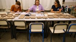 Election staffers get ready to start the count of votes after the closing of the voting during the presidential runoff election in Montevideo on November 24, 2024. Uruguayans voted on Sunday to elect their next president in an open-ended ballot that could mark the return to power of the left of the iconic former president José Mujica or the continuity of the center-right coalition after five years in power. (Photo by EITAN ABRAMOVICH / AFP) (Photo by EITAN ABRAMOVICH/AFP via Getty Images)