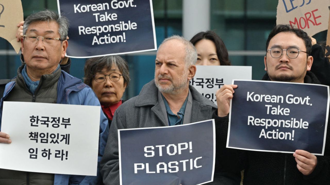 Activists gather in the grounds outside BEXCO, the venue for the fifth session of the UN Intergovernmental Negotiating Committee on Plastic Pollution (INC-5), in Busan on November 25, 2024. (Photo by Anthony WALLACE / AFP) (Photo by ANTHONY WALLACE/AFP via Getty Images)