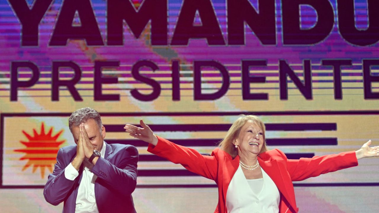 Uruguay's president-elect, Yamandu Orsi, of the Frente Amplio coalition, and vice president-elect, Carolina Cosse, greet supporters after the presidential runoff election in Montevideo on November 24, 2024. The leftist Yamandú Orsi, elected president of Uruguay after Sunday's ballot, promised to call 'again and again' for national dialogue in a speech to his supporters after the election results showed him as the winner. (Photo by Santiago Mazzarovich / AFP) (Photo by SANTIAGO MAZZAROVICH/AFP via Getty Images)