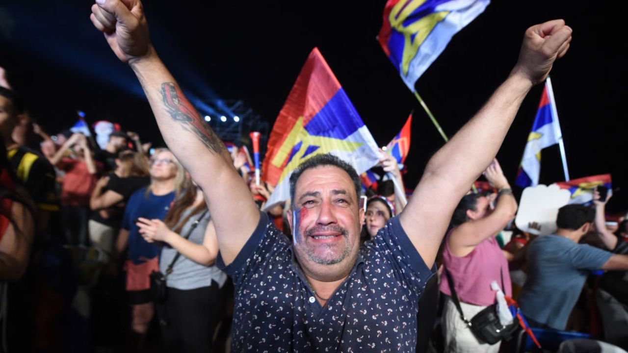 TOPSHOT - A supporter of Uruguay's president-elect, Yamandu Orsi, of the Frente Amplio coalition, celebrates after the presidential runoff election in Montevideo on November 24, 2024. The leftist Yamandú Orsi, elected president of Uruguay after Sunday's ballot, promised to call 'again and again' for national dialogue in a speech to his supporters after the election results showed him as the winner. (Photo by Dante FERNANDEZ / AFP) (Photo by DANTE FERNANDEZ/AFP via Getty Images)