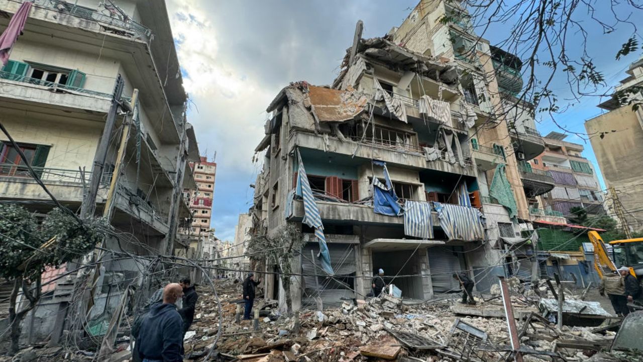 People inspect the damage at the site of overnight Israeli airstrikes that targeted the neighbourhood of Ghobeiry in Beirut's southern suburbs on November 25, 2024, amid the ongoing war between Israel and Hezbollah. (Photo by AFP) (Photo by -/AFP via Getty Images)