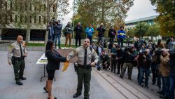 VAN NUYS, CALIFORNIA - NOVEMBER 25: A police officer selects people to watch the proceedings in court at the Van Nuys West Courthouse before a status hearing on the muder conviction of Lyle and Erik Menendez on November 25, 2024 in Van Nuys, California. The Menendez brothers have spent over 30 years in prison for the 1989 murders of their parents, José and Kitty Menendez, at their Beverly Hills mansion. (Photo by Apu Gomes/Getty Images)