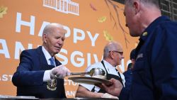 US President Joe Biden (L) serves food at a "Friendsgiving" dinner in honor of the upcoming Thanksgiving holiday with service members and their families at the Coast Guard Sector New York in Staten Island, New York, November 25, 2024. (Photo by SAUL LOEB / AFP) (Photo by SAUL LOEB/AFP via Getty Images)