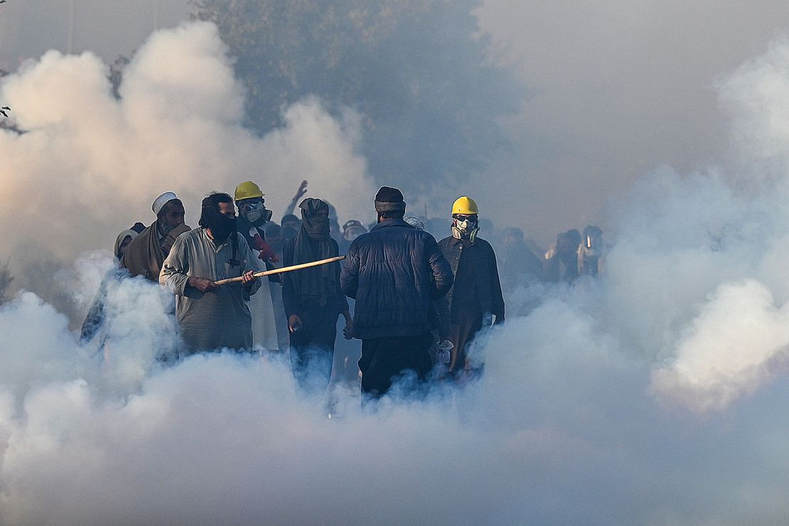 Policemen fire tear gas shells to disperse supporters of Pakistan Tehreek-e-Insaf (PTI) party during a protest to demand the release of former prime minister Imran Khan, in Islamabad on November 26.