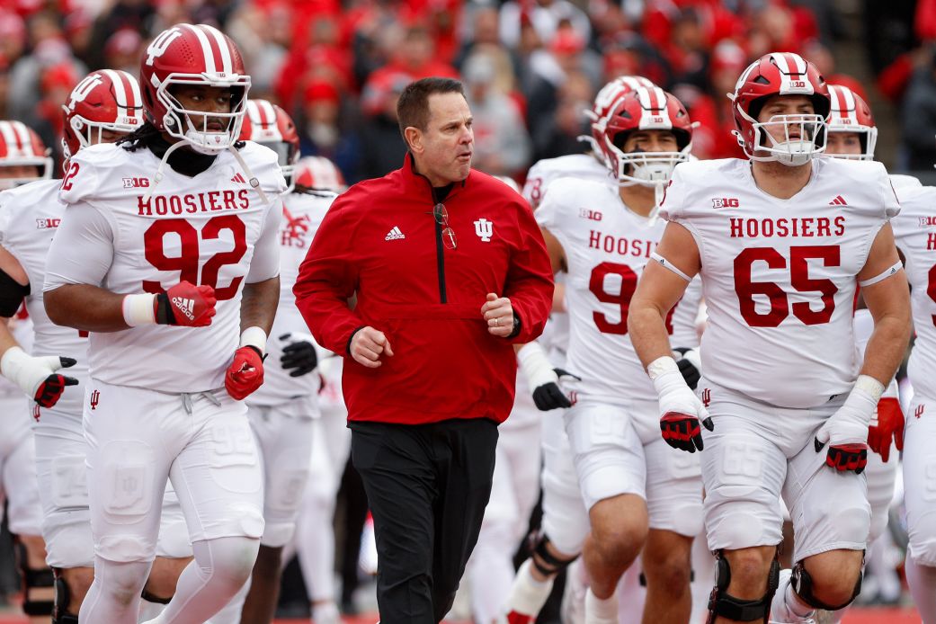 Indiana Hoosiers head coach Curt Cignetti runs onto the field with his team before a game against Ohio State.