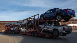 A truck loaded with pickups drives to cross to the US next to the border wall at the Otay commercial crossing port in Tijuana, Baja California state, Mexico on November 26, 2024. US President-elect Trump said Monday he would impose a 25 percent tariff on all imports from Mexico and Canada as one of his first actions upon becoming US president in January.