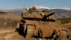 NORTHERN ISRAEL, ISRAEL - NOVEMBER 26: An Israeli soldier stands on a tank as it is moving along the border with Lebanon on November 26, 2024 in Northern Israel, Israel. Israel's cabinet is discussing a proposed 60-day ceasefire deal with Hezbollah, the Lebanese militant group whom Israel launched a ground invasion against almost two months ago, after trading cross-border fire since early October 2023. (Photo by Amir Levy/Getty Images)