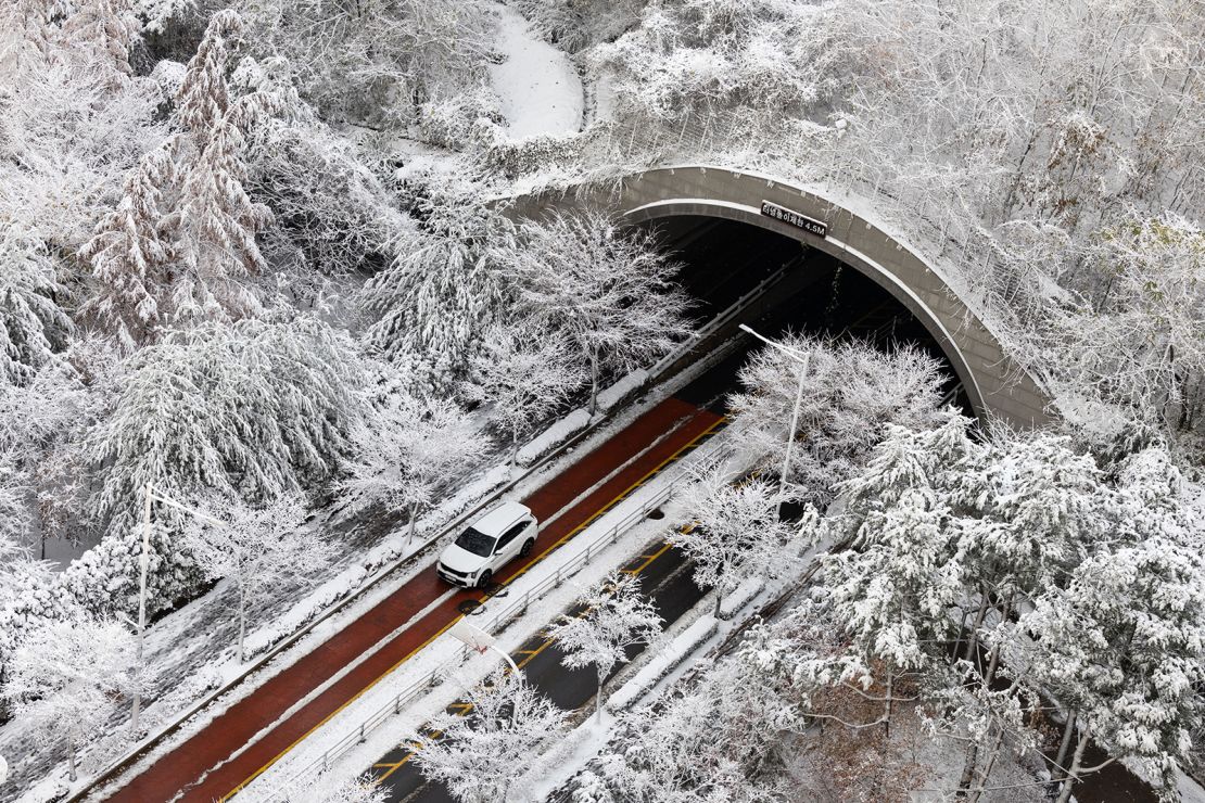 A vehicle exits a tunnel as snow falls in Gimpo.