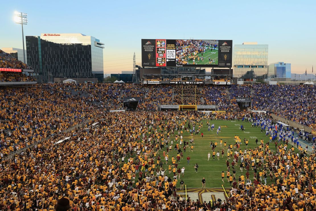 Fans rushed the field prematurely as one second was put back on the game clock after an official review.