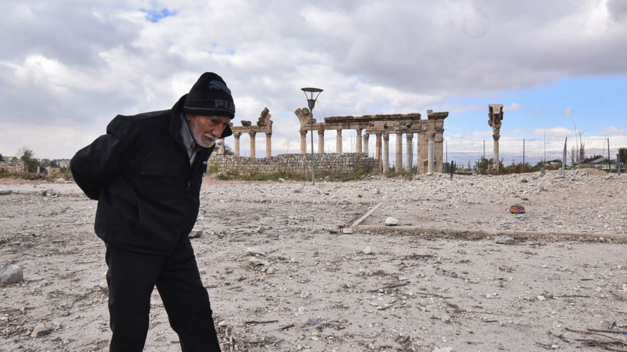 TOPSHOT - An elderly man walks through a previously bombarded area in front of the Roman ruins of the ancient city of Baalbek in Lebanon's eastern Bekaa Valley on November 28, 2024, a day after a ceasefire between Israel and Hezbollah took hold. Several Israeli strikes in recent weeks on Baalbek in east Lebanon and Tyre in the south -- both Hezbollah strongholds -- hit close to ancient Roman ruins designated as UNESCO World Heritage sites. (Photo by Fadel ITANI / AFP) (Photo by FADEL ITANI/AFP via Getty Images)