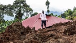 A man stands in front of a house buried in mud following flooding and landslides in Masugu on November 28, 2024. Landslides in several villages in eastern Uganda have killed 15 people and left more than 100 unaccounted for, police said on November 28, 2024. The East African country has been deluged by heavy rains in the past few days, with the government issuing a national disaster alert after reports of flooding and landslides. (Photo by Charles Nambasi / AFP) (Photo by CHARLES NAMBASI/AFP via Getty Images)