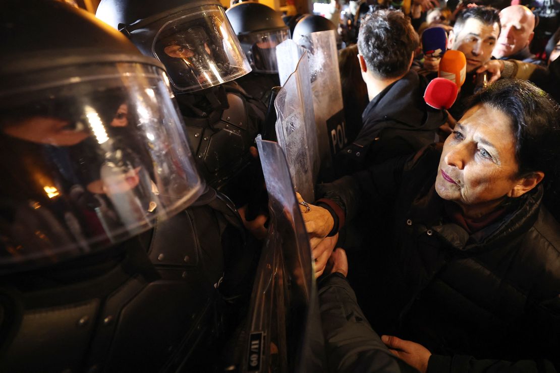 Georgia's President Salome Zourabichvili confronts police holding riots shields in Tbilisi on Thursday.