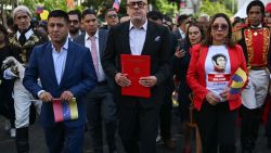 National Assembly President Jorge Rodriguez (C) walks as he holds a document of a bill passed by lawmakers that codifies economic sanctions as a crime against humanity and allows for the prosecution of anyone who expresses support for the measures in Caracas on 28 November 2024. Venezuela's parliament, controlled by the ruling Chavismo party, approved a law on Thursday that punishes with 25 to 30 years in prison the support of international sanctions against the country, in addition to establishing 60-year disqualifications for leaders who support them. (Photo by Juan BARRETO / AFP) (Photo by JUAN BARRETO/AFP via Getty Images)