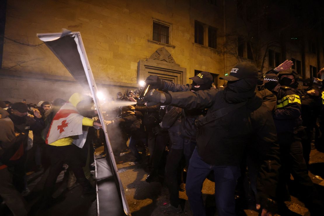 Police fire tear gas at protesters outside the parliament in Tbilisi on Thursday.