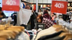 People shop at a Guess store for early Black Friday deals on Thanksgiving Day, November 28, 2024, at the Citadel Outlets shopping center in Los Angeles. Stores at the Citadel Outlet shopping center opened at 8pm on Thursday November 28 and will remain open all night for their "Black Friday Early Access Event." (Photo by Robyn Beck / AFP) (Photo by ROBYN BECK/AFP via Getty Images)