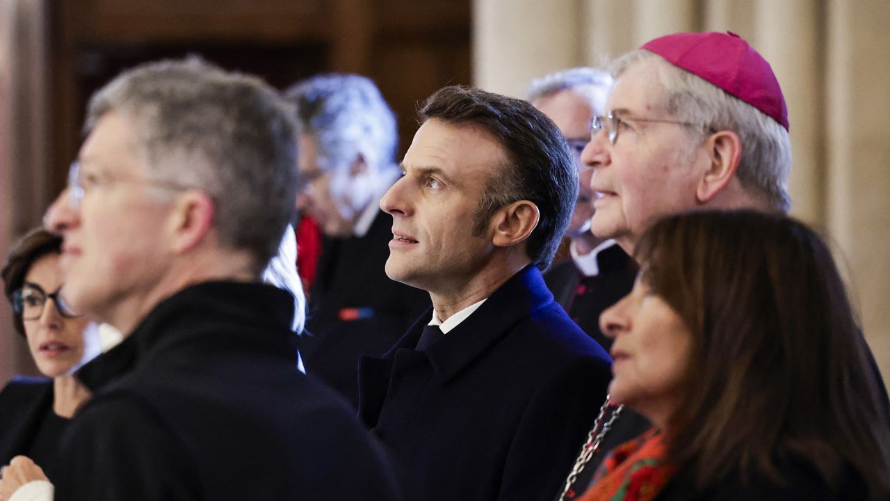 (From C-L) French President Emmanuel Macron, Paris' archbishop Laurent Ulrich and Paris' mayor Anne Hidalgo look up during a visit of Notre-Dame de Paris cathedral in Paris, on November 29, 2024. The Notre-Dame Cathedral is set to re-open early December 2024, with a planned weekend of ceremonies on December 7 and 8, 2024, five years after the 2019 fire which ravaged the world heritage landmark and toppled its spire. Some 250 companies and hundreds of experts were mobilised for the five-year restoration costing hundreds of millions of euros. (Photo by STEPHANE DE SAKUTIN / POOL / AFP) (Photo by STEPHANE DE SAKUTIN/POOL/AFP via Getty Images)