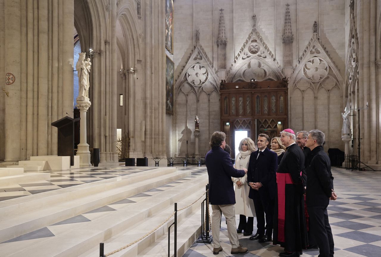 French President Emmanuel Macron, his wife Brigitte Macron and Paris' archbishop Laurent Ulrich visit Notre Dame cathedral and stop in front of the Virgin of Paris statue.