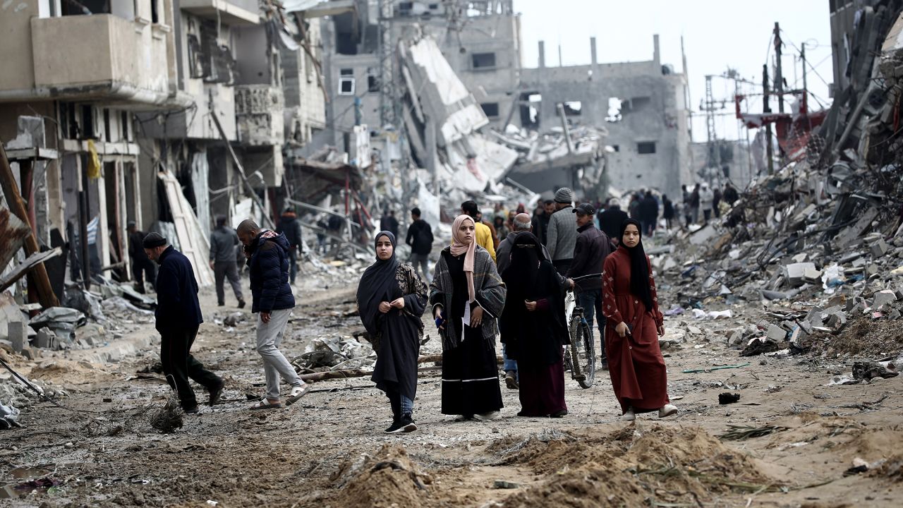 Palestinians return to Nuseirat in the central Gaza Strip after Israeli shelling of the camp stopped on November 29, 2024, amid the ongoing war in the Palestinian territory between Israel and Hamas. (Photo by Eyad BABA / AFP) (Photo by EYAD BABA/AFP via Getty Images)