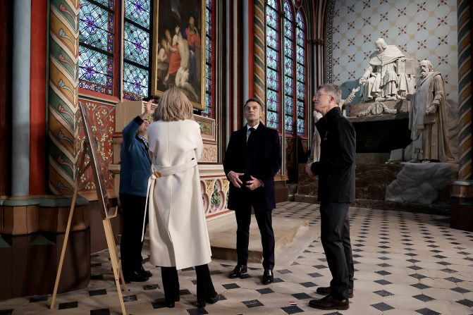 Macron meets with Marie Parant, who restored murals in the Saint Marcel's chapel within the building. Twenty-nine chapels surround the interior of the cathedral. They were not part of the original plans for the space but added in the 13th century.