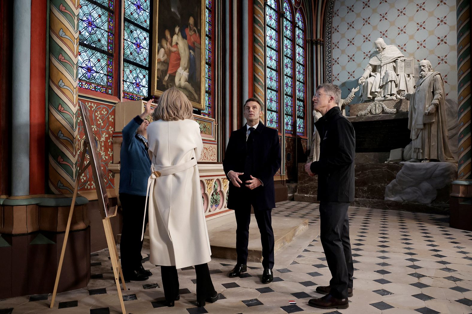 President Emmanuel Macron meets with Marie Parant, who restored murals in the Saint Marcel's chapel within the building. Twenty-nine chapels surround the interior of the cathedral. They were not part of the original plans for the space but added in the 13th century.