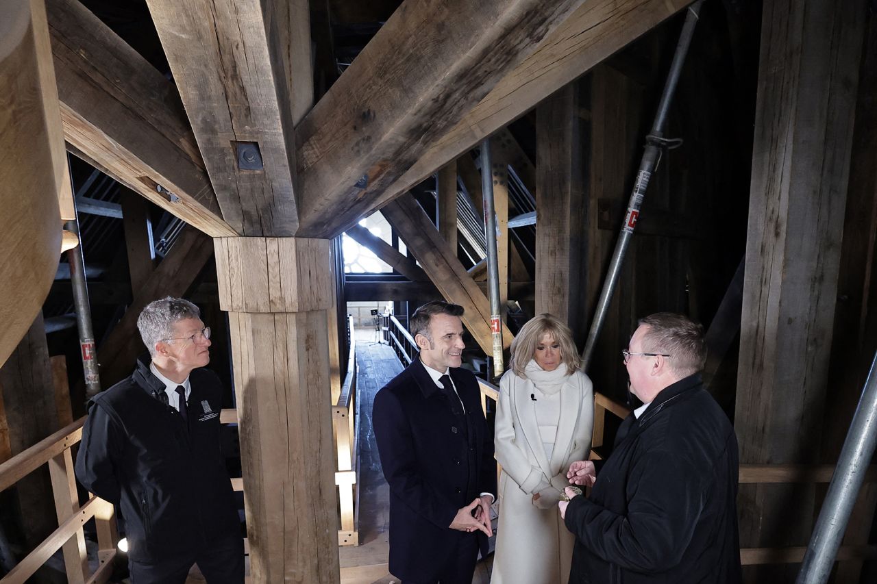 French President Emmanuel Macron and his wife Brigitte Macron visit the spire of Notre-Dame cathedral.