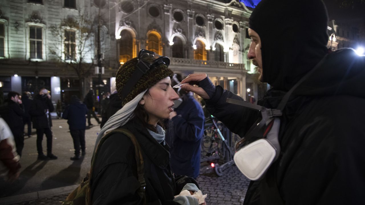 TBILISI, GEORGIA - NOVEMBER 29: Demonstrators helping each other from tear gas during a protest outside the parliament on November 29, 2024 in Tbilisi, Georgia. Second day the protesters gather outside the Georgian parliament in Tbilisi after Georgian Prime Minister Irakli Kobakhidze announced Thursday that he is suspending the South Caucus nation's bid for EU hip until the end of 2029, following a European Parliament resolution that deemed October's parliamentary elections as invalid. The country's president, Salome Zourabichvili, alleges last month's parliamentary election, which was won by the ruling Georgian Dream party, was "stolen" amid Russian interference. (Photo by Daro Sulakauri/Getty Images)