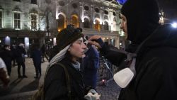 TBILISI, GEORGIA - NOVEMBER 29: Demonstrators helping each other from tear gas during a protest outside the parliament on November 29, 2024 in Tbilisi, Georgia. Second day the protesters gather outside the Georgian parliament in Tbilisi after Georgian Prime Minister Irakli Kobakhidze announced Thursday that he is suspending the South Caucus nation's bid for EU membership until the end of 2029, following a European Parliament resolution that deemed October's parliamentary elections as invalid. The country's president, Salome Zourabichvili, alleges last month's parliamentary election, which was won by the ruling Georgian Dream party, was "stolen" amid Russian interference. (Photo by Daro Sulakauri/Getty Images)