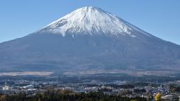 This photo taken on November 28, 2024 shows Mount Fuji pictured behind the city of Gotemba, Shizuoka prefecture, some 100 kms southwest of Tokyo. (Photo by Richard A. Brooks / AFP) (Photo by RICHARD A. BROOKS/AFP via Getty Images)