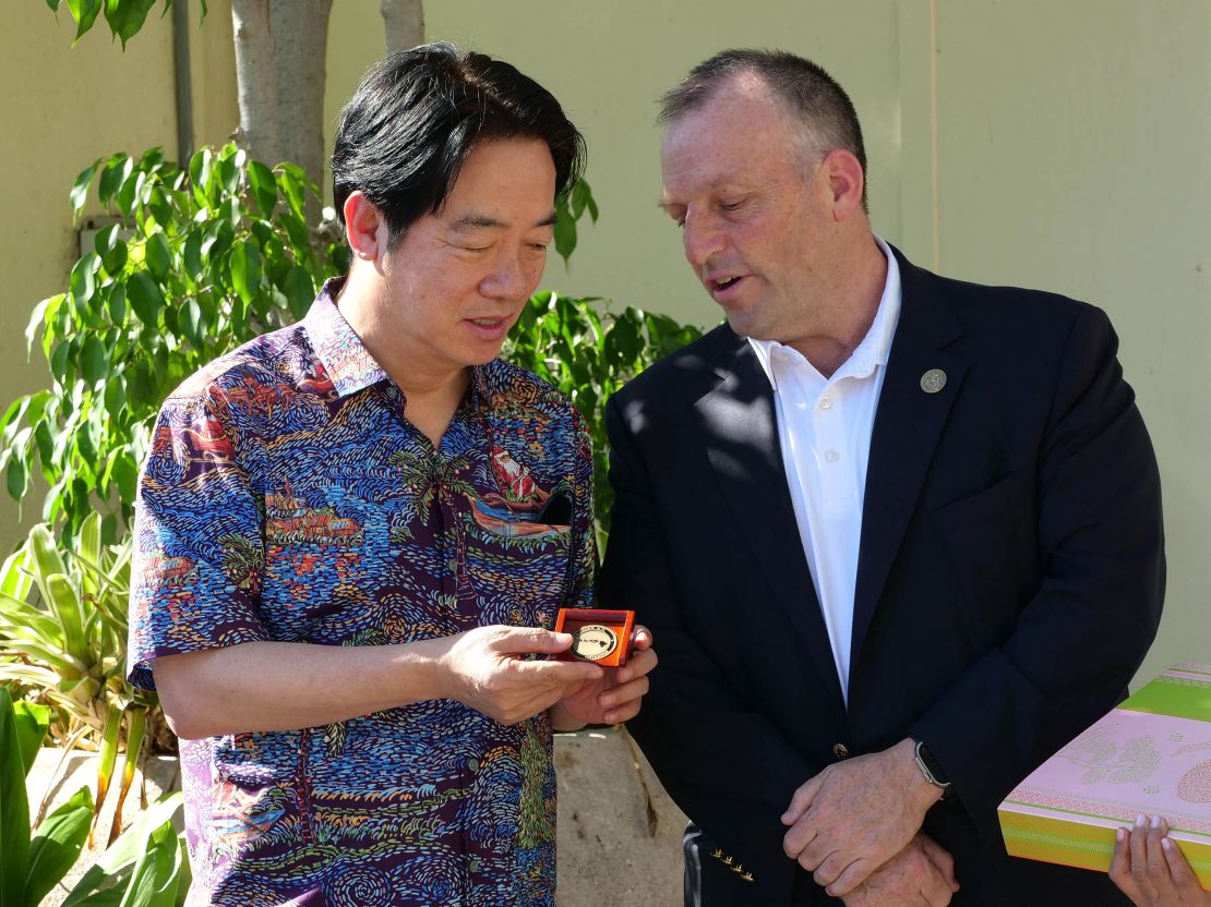 Taiwanese President Lai Ching-te is presented with a gift from Hawaii Governor Josh Green at the Hawaii Emergency Management Agency in Honolulu, Hawaii, on November 30, 2024.