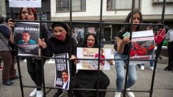 Demonstrators hold signs against the government of Venezuelan President Nicolas Maduro as they prettend to be imprisoned during a rally in Bogota December 1, 2024. (Photo by Alejandro Martinez / AFP) (Photo by ALEJANDRO MARTINEZ/AFP via Getty Images)