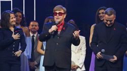 LONDON, ENGLAND - DECEMBER 01: (L to R) Shaina Taub, Sir Elton John and David Furnish speak on stage at "The Devil Wears Prada Musical" charity gala night in support of the Elton John Aids Foundation at The Dominion Theatre on December 1, 2024 in London, England. (Photo by Dave Benett/Getty Images for The Devil Wears Prada Musical)